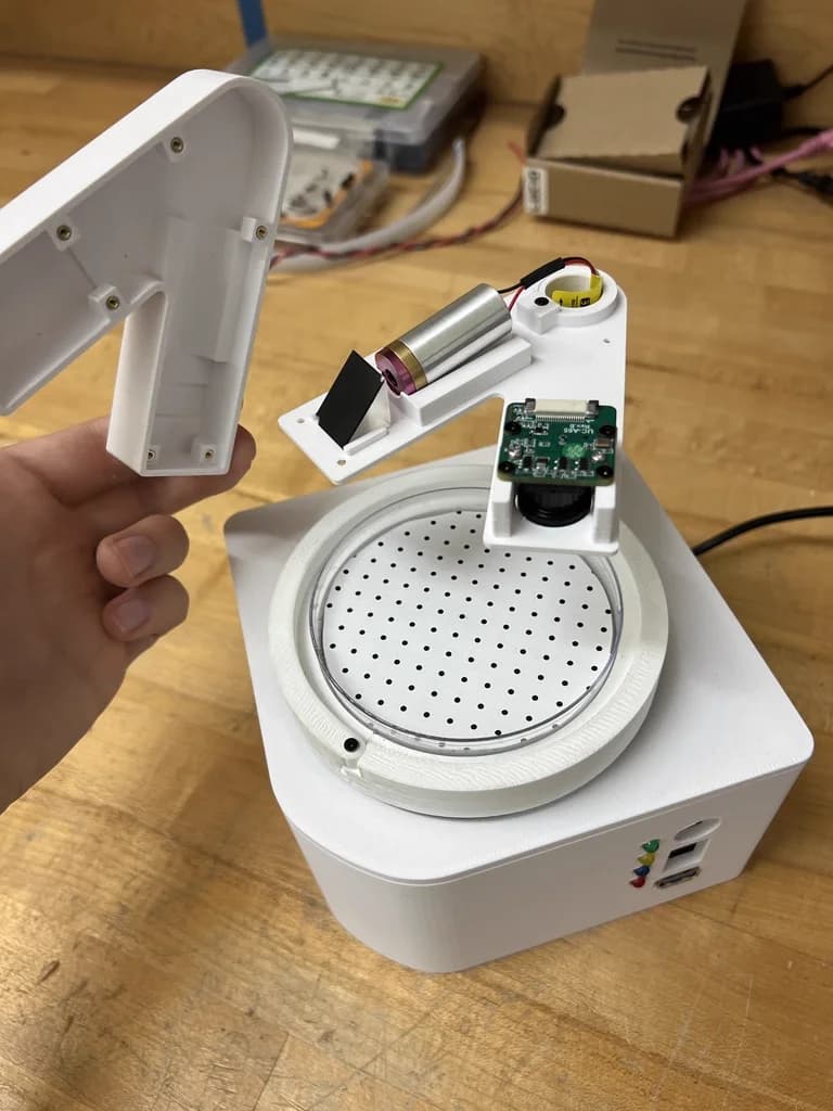 The laser and camera arm assembly for precise targeting